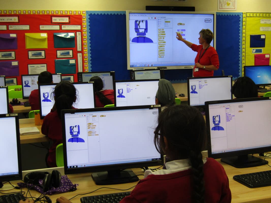 Children with Ohbots in classroom